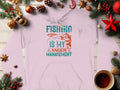 A light pink hoodie from Garment Graphics Anglers Wardrobe collection featuring Fishing is my anger management in teal and red, displayed on wood with holiday decor like pinecones, fir branches, ornaments, and a steaming cup.