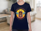 Someone is wearing a black womens t-shirt from Garment Graphics Summer Edition, featuring a cartoon bee with sunglasses and the text Bee Yourself, Everyone Else is Taken in a circular design. The scene has a blurred indoor background.