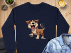 Garment Graphics presents a navy sweatshirt with an animated happy dog print, ideal for dog lovers. The playful pup has large eyes and a wagging tail. Displayed on wood, its styled with a denim jacket, coffee, and a nearby plant.