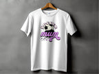 A white T-shirt from Garment Graphics features Soccer Mum in stylized text with a dynamic soccer ball, lines, and stars. This classic fit tee is expertly designed and gracefully hangs on a wooden hanger against a gray background.