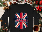 The black unisex sweatshirt by Garment Graphics, featuring a Union Jack and Dont Blame Me, I Didnt Vote For Him, is surrounded by festive Christmas décor like ornaments, pine branches, and a steaming mug.