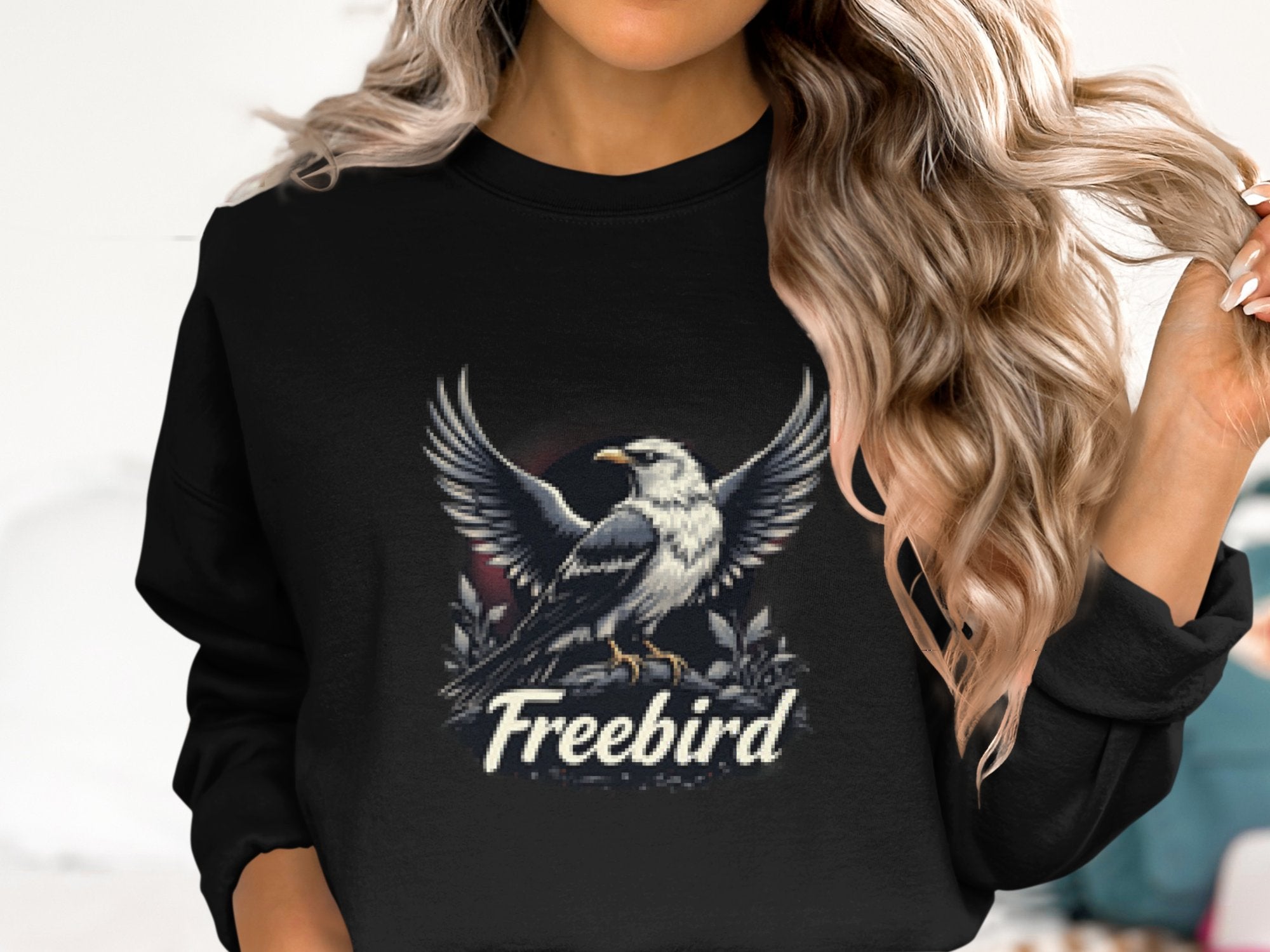 A person with long wavy hair wears a black Garment Graphics Freebird Sweatshirt showcasing an eagle in flight. It offers unisex sizing, ensuring a comfy fit for all.