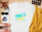 The Garment Graphics white shirt showcases a vibrant Take It Easy graphic with arrows and music notes. Ideal for pairing with a yellow blazer, pink shoes, sunglasses, makeup brushes, eyeshadow palette, and nail polish on wood for the perfect casual look.