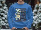 A person wears a blue graphic sweatshirt from Garment Graphics featuring a cartoon alligator dribbling a basketball with the text See You Later Alligator, set against blurred, snow-covered trees.
