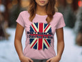Wearing a vibrant Garment Graphics pink cotton t-shirt with a distressed British flag and the bold message, “DONT BLAME ME, I Didnt Vote For Him,” someone stands against a softly blurred, snow-kissed scene.