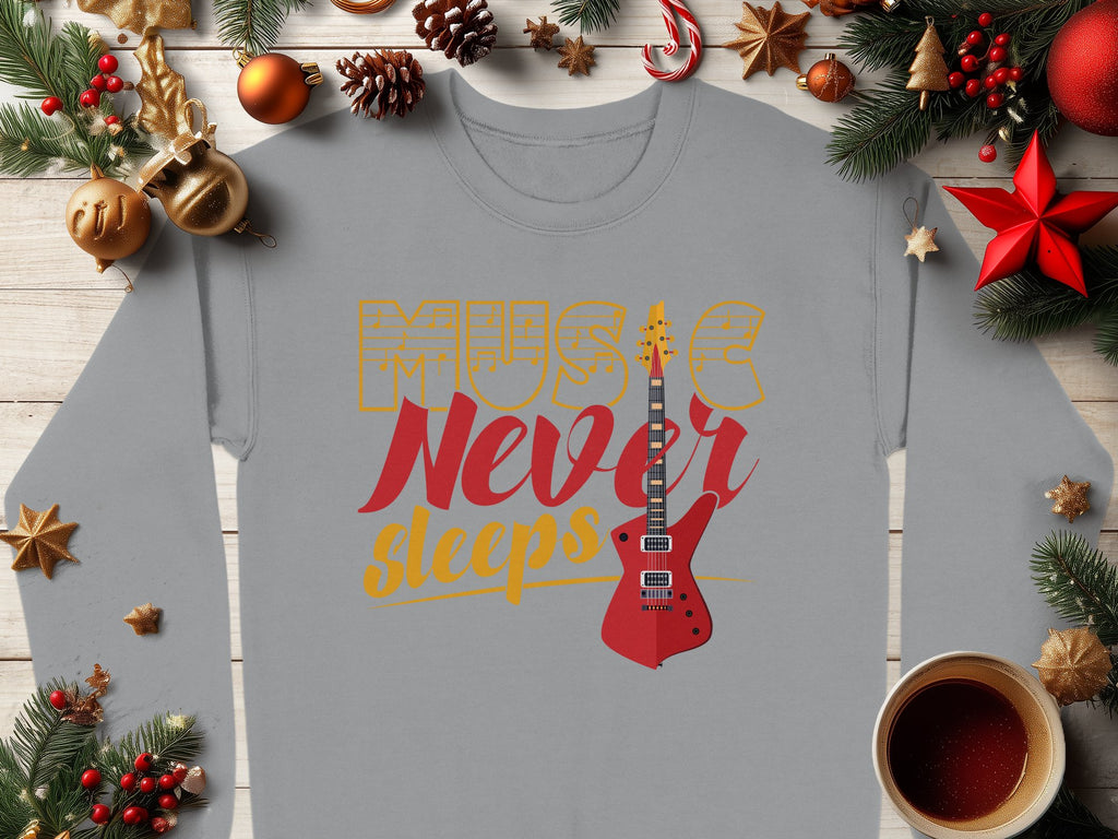 Garment Graphics offers a vibrant gray, long-sleeve guitar-themed sweatshirt featuring Music Never Sleeps and a red electric guitar graphic. Ideal for music lovers, it’s showcased amid Christmas decor like pine branches, ornaments, and a red star on a wooden surface.