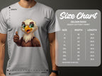 A person in a gray Garment Graphics Eagle T-shirt with a cartoon eagle giving a thumbs up adds flair to casual wear. The tee is made from Gildan 5000 heavy cotton, available in sizes S to 5XL, each with specific width and length measurements.