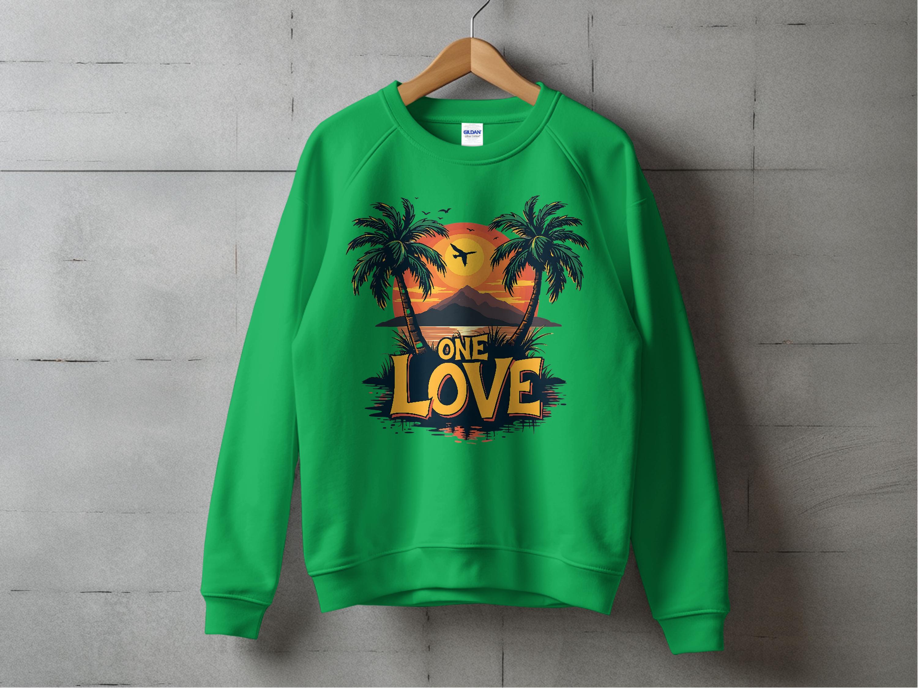 A green sweatshirt by Garment Graphics hangs on a wooden hanger against a concrete wall, featuring a vibrant sunset between palm trees and bold One Love lettering. Unisex sizing ensures this One Love Sweatshirt embodies effortless style and comfort.