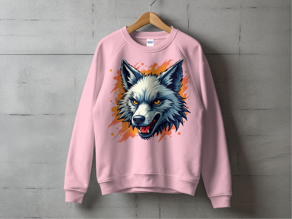 A pink sweatshirt featuring a wolf face design by Garment Graphics is displayed on a wooden hanger against a concrete wall. The wolf illustration, highlighted in blue, white, and orange, with an open mouth and sharp teeth, adds unique flair to this striking piece of clothing.