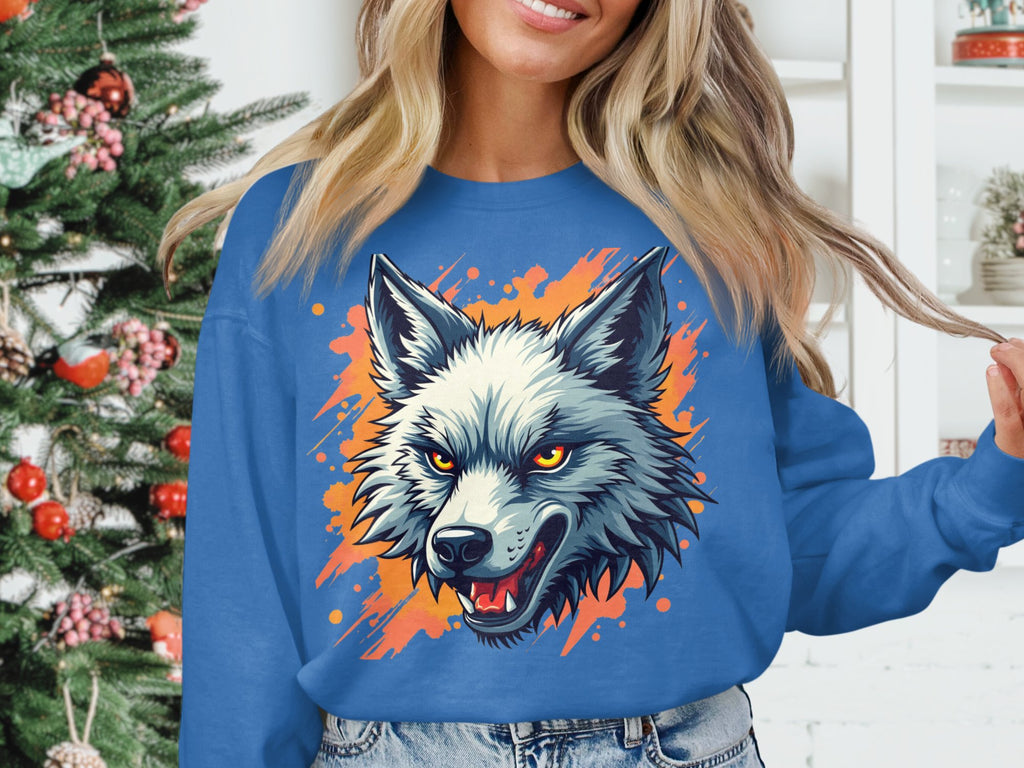A person wears a bold Garment Graphics wolf sweatshirt, highlighting their wild side with a sharp-toothed design and striking orange accents. In the background, a Christmas tree adds festive cheer next to shelves adorned with decor items.