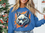 A person wears a bold Garment Graphics wolf sweatshirt, highlighting their wild side with a sharp-toothed design and striking orange accents. In the background, a Christmas tree adds festive cheer next to shelves adorned with decor items.