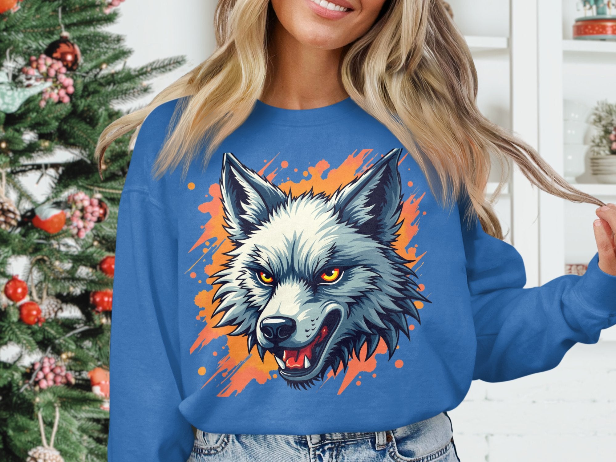 A person wears a bold Garment Graphics wolf sweatshirt, highlighting their wild side with a sharp-toothed design and striking orange accents. In the background, a Christmas tree adds festive cheer next to shelves adorned with decor items.