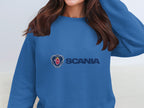 A person is wearing a blue Garment Graphics sweatshirt featuring the Scania logo and text on the front, ideal for casual outings. The unisex sizing guarantees a comfortable fit for all.