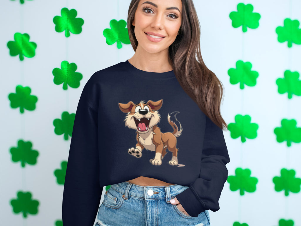 A woman in a Garment Graphics black sweatshirt with an animated happy dog illustration stands by a wall of green shamrocks. Her long brown hair flows over her shoulders as she smiles gently, creating an ideal scene for dog lovers.
