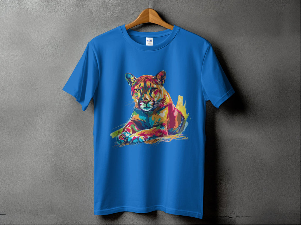 A Garment Graphics blue T-shirt features a vibrant artwork of a colorful stylized panther resting in bright hues, artistically set against a textured gray background to enhance the vivid design.