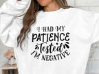 Garment Graphics presents a quirky unisex sweatshirt ideal for casual outings, featuring bold black text: I had my patience tested, Im negative. This design emphasizes the upper garment and offers a peek at the wearers hair.