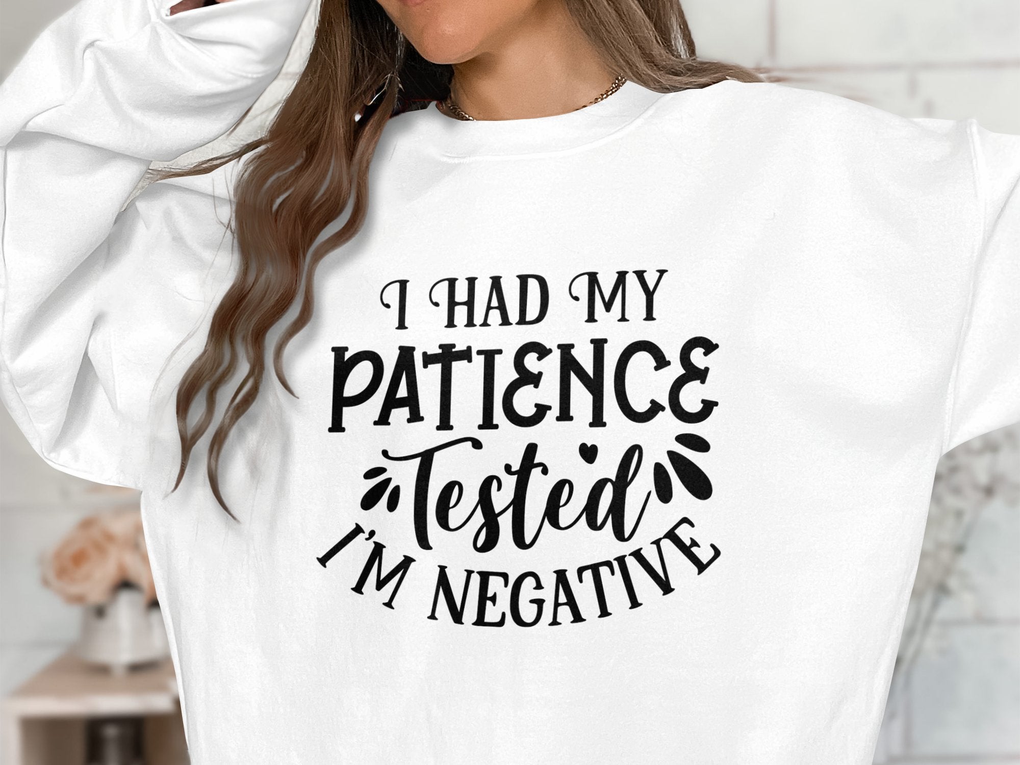 Garment Graphics presents a quirky unisex sweatshirt ideal for casual outings, featuring bold black text: I had my patience tested, Im negative. This design emphasizes the upper garment and offers a peek at the wearers hair.