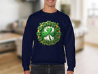 A person wears a navy blue sweatshirt by Garment Graphics, featuring a bold circular design that embodies an Irish spirit. A prominent green shamrock at the center echoes a lucky four-leaf clover, with the blurred indoor setting enhancing this unique pieces charm.