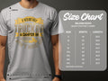 A person sports a gray Garment Graphics T-shirt with the witty quote: If he’s got golf clubs in his truck or a camper in his driveway, don’t hire him. To the right, a size chart for the Gildan 5000 Heavy Cotton T-shirt, ideal for camping trips and golf outings.