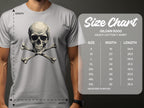 Wearing a trendy gray graphic T-shirt from Garment Graphics, the man flaunts a bold skull and crossbones design. Beside him, the size chart for Gildan 5000 heavy cotton lists sizes S to 5XL with corresponding width and length measurements in inches.