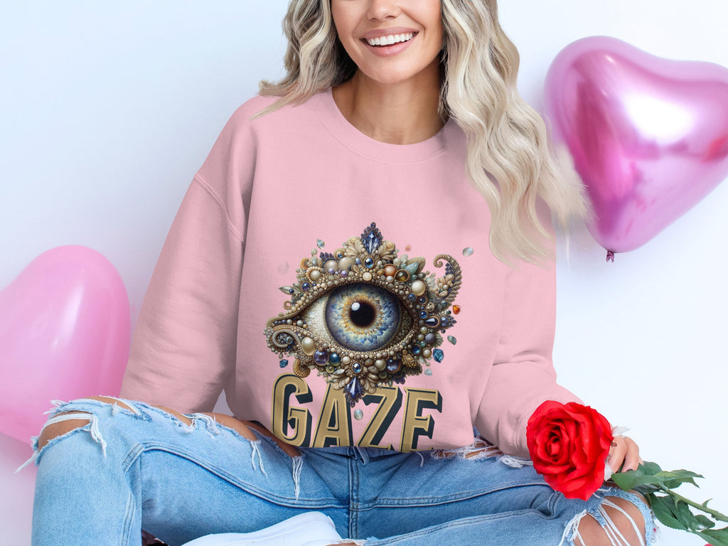A person in a Garment Graphics pink sweatshirt with an eye design and GAZE text holds a red rose, surrounded by pink heart balloons. They wear ripped jeans, and their long, wavy blonde hair adds charm to this unisex look.