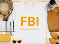 A white sweatshirt from Garment Graphics features FBI Female Boob Inspector in yellow letters. It’s styled with yellow accessories like a purse, sunglasses, pen on notebook, scarf, jacket, and cup on wood. Unisex sizing makes it perfect for fans of playful fashion.