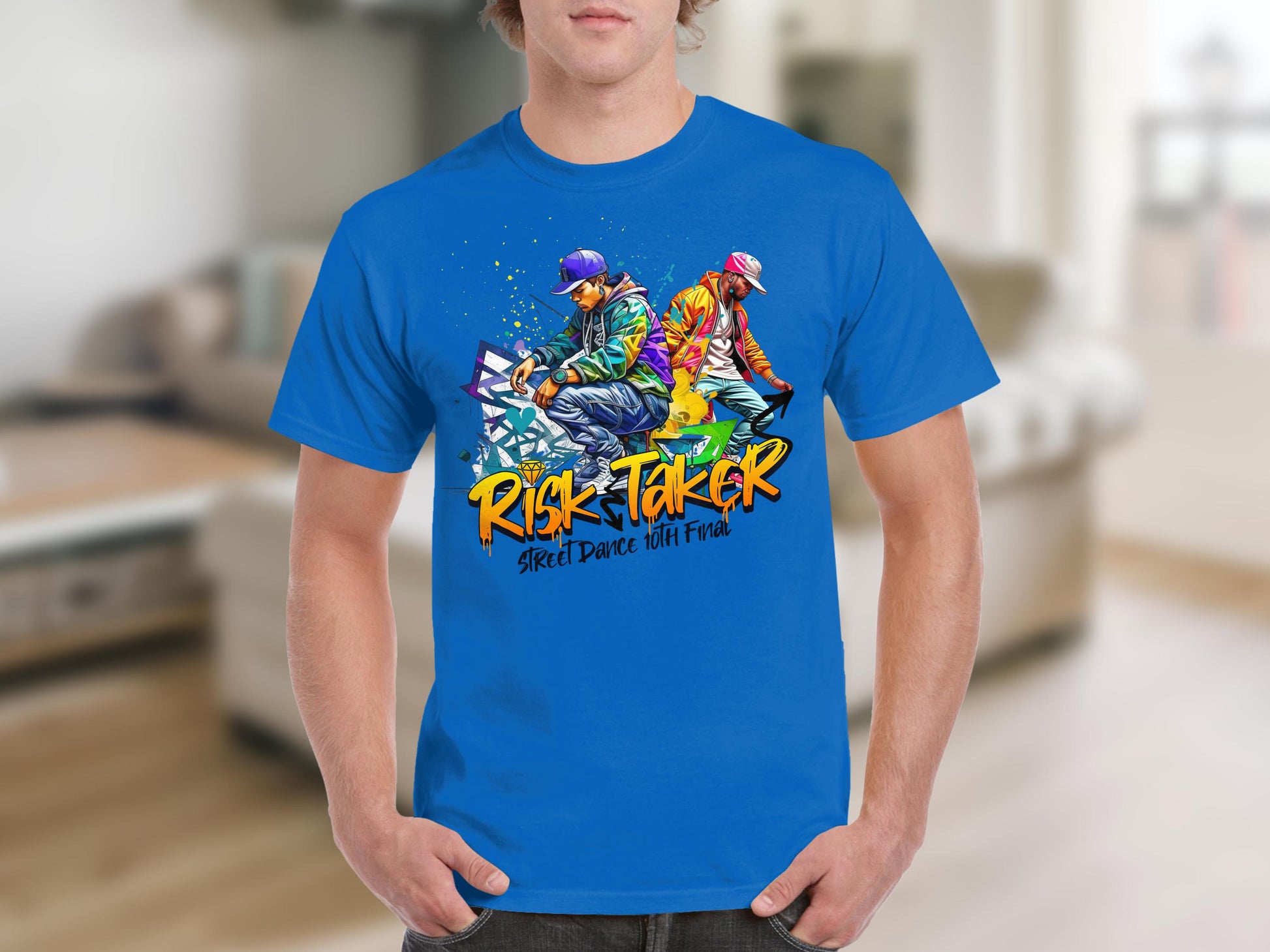 Clad in a Garment Graphics blue t-shirt showcasing two dancers in vibrant attire, someone celebrates street dance culture. The shirt boasts the text Risk Taker Street Dance 10th Final against a blurred indoor background.