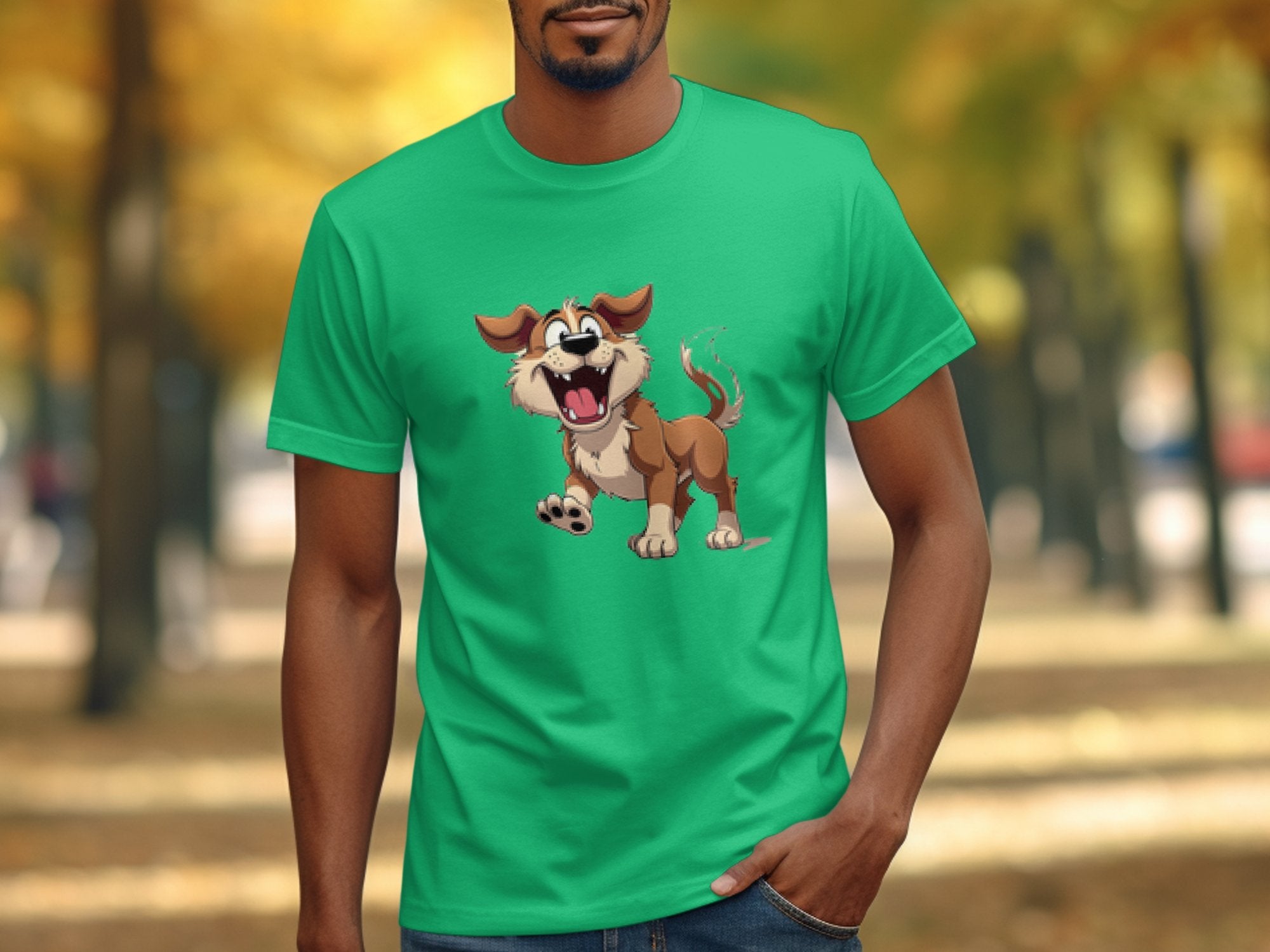A person in a Garment Graphics green T-shirt for dog lovers sports a cartoon dog with floppy ears and an open mouth, set against blurred trees with autumn-colored leaves adding seasonal charm.