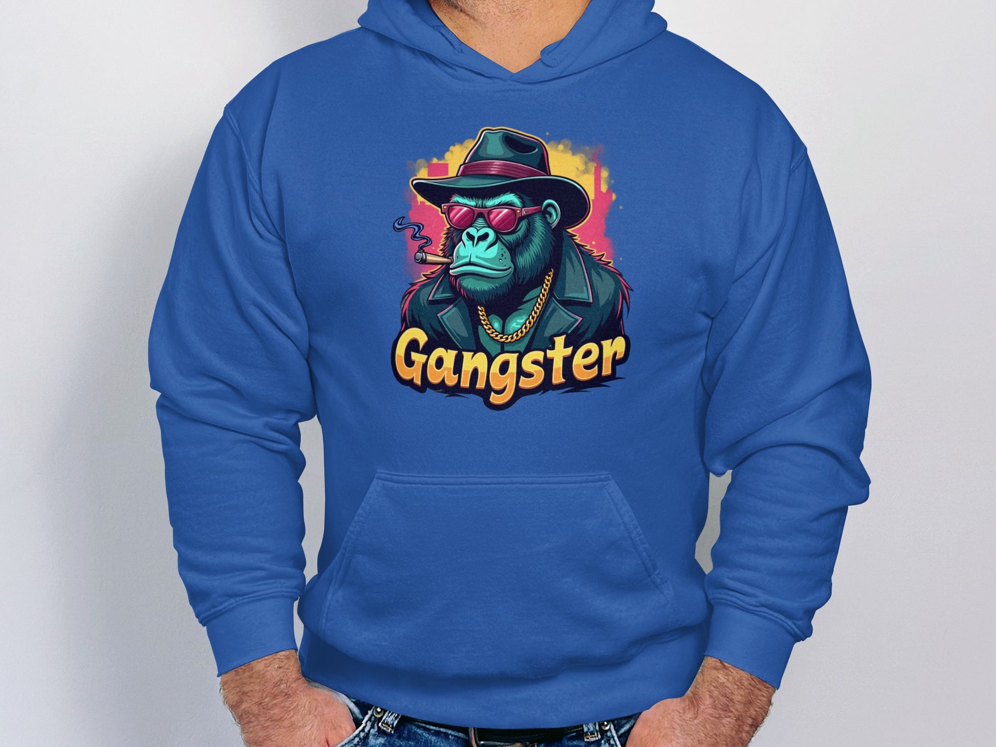 Sporting a Garment Graphics blue hoodie, a gangster ape in a hat, sunglasses, and gold chain exudes hipster urban flair. The bold design is topped off with Gangster below the image for added edge.