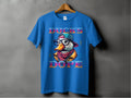 A blue T-shirt from Garment Graphics hangs on a wooden hanger against a gray background, showcasing a duck wearing glasses, a hat, and a colorful scarf. The text Ducks Dope appears in stylized font, capturing its unique style and eye-catching design.