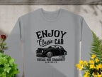 The Garment Graphics gray sweatshirt boasts a vintage car graphic with Enjoy Classic Car and Vintage Ride Community Aircooled, Estd. 1980, surrounded by red and yellow flowers—ideal for classic car enthusiasts who appreciate stylish apparel.