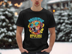 A person stands in a snowy landscape, wearing a black Garment Graphics Dog T-Shirt featuring a vibrant dog in sunglasses with Paw-sitive Stylish and Chillin Like A Canine Villain printed underneath.