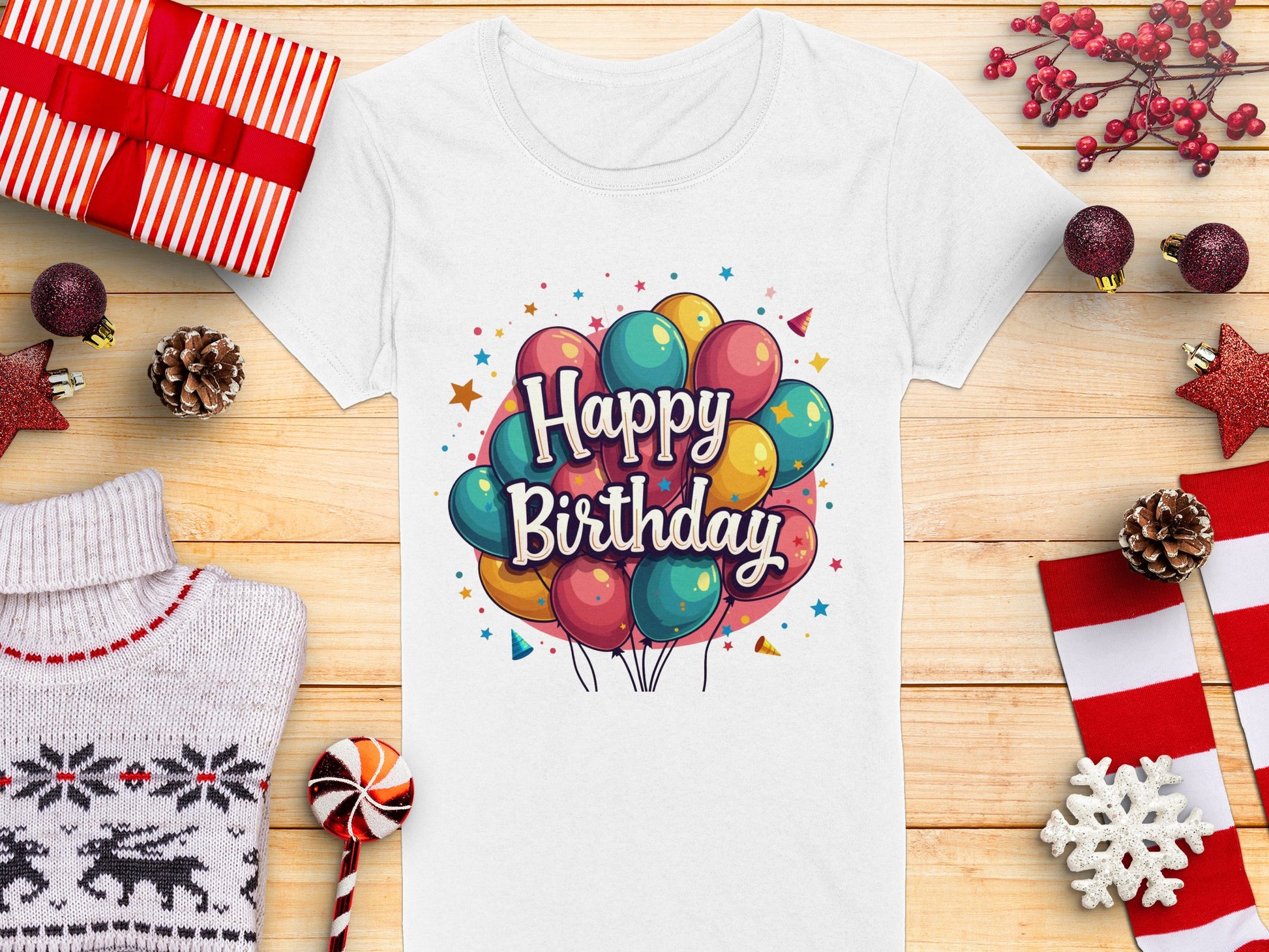 The vibrant white t-shirt from Garment Graphics is perfect for a birthday celebration. It features a colorful balloon graphic and Happy Birthday text, crafted from 100% cotton, making it an ideal match for festive items like wrapped gifts and red ornaments.
