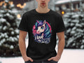 In a snowy outdoor setting, a person wears a black Garment Graphics Unicorn T-shirt with a vibrant pony graphic and the text I love my pony beneath it. Trees and snow form a picturesque backdrop for this unicorn enthusiasts standout piece.