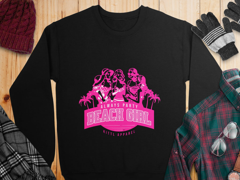 Garment Graphics black sweatshirt boasts a pink graphic of three women with palm trees and the text Always Party Beach, styled with a red knit hat, black and gray gloves, and a plaid button-up shirt on a wooden surface from their vibrant collection.