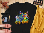Garment Graphics black sweatshirt features a vibrant graffiti-style image of two posing figures and the text Risk Taker Street Dance. Pair it with a yellow blazer, makeup, sunglasses, moccasins, and a small bag for an ultimate bold look perfect for street dance finals.