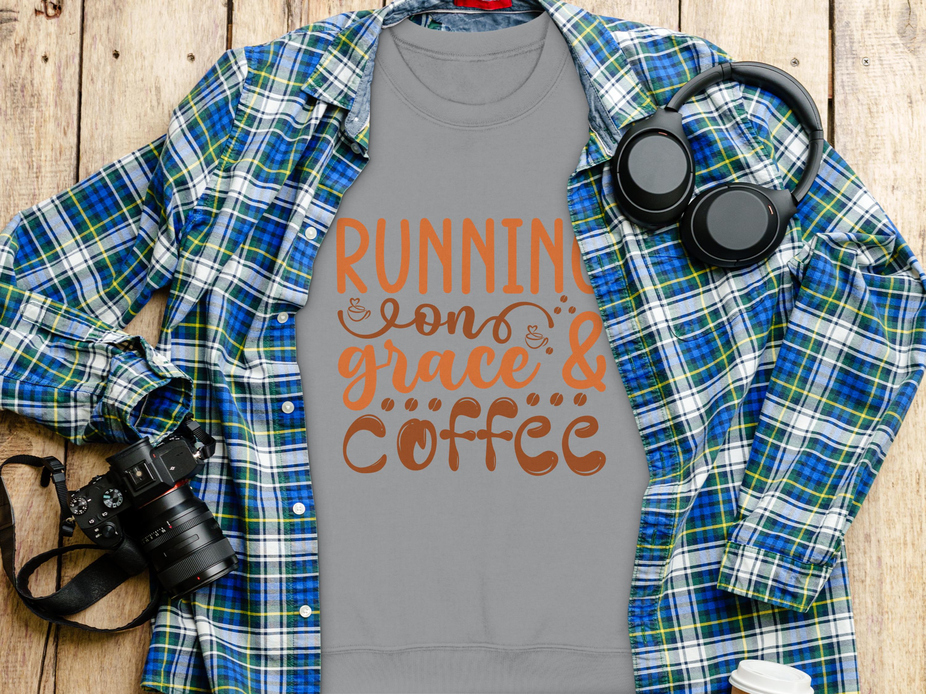 Garment Graphics offers a gray unisex T-shirt with Running on Grace & Coffee in orange and brown. Styled on a wooden surface with a blue plaid shirt, headphones, camera, and coffee cup, its ideal for embracing life fueled by grace and caffeine.