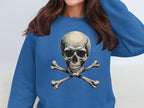 A woman embodies edgy style in a Garment Graphics blue sweatshirt featuring a bold skull and crossbones design. Her hidden face adds intrigue to the unisex look.