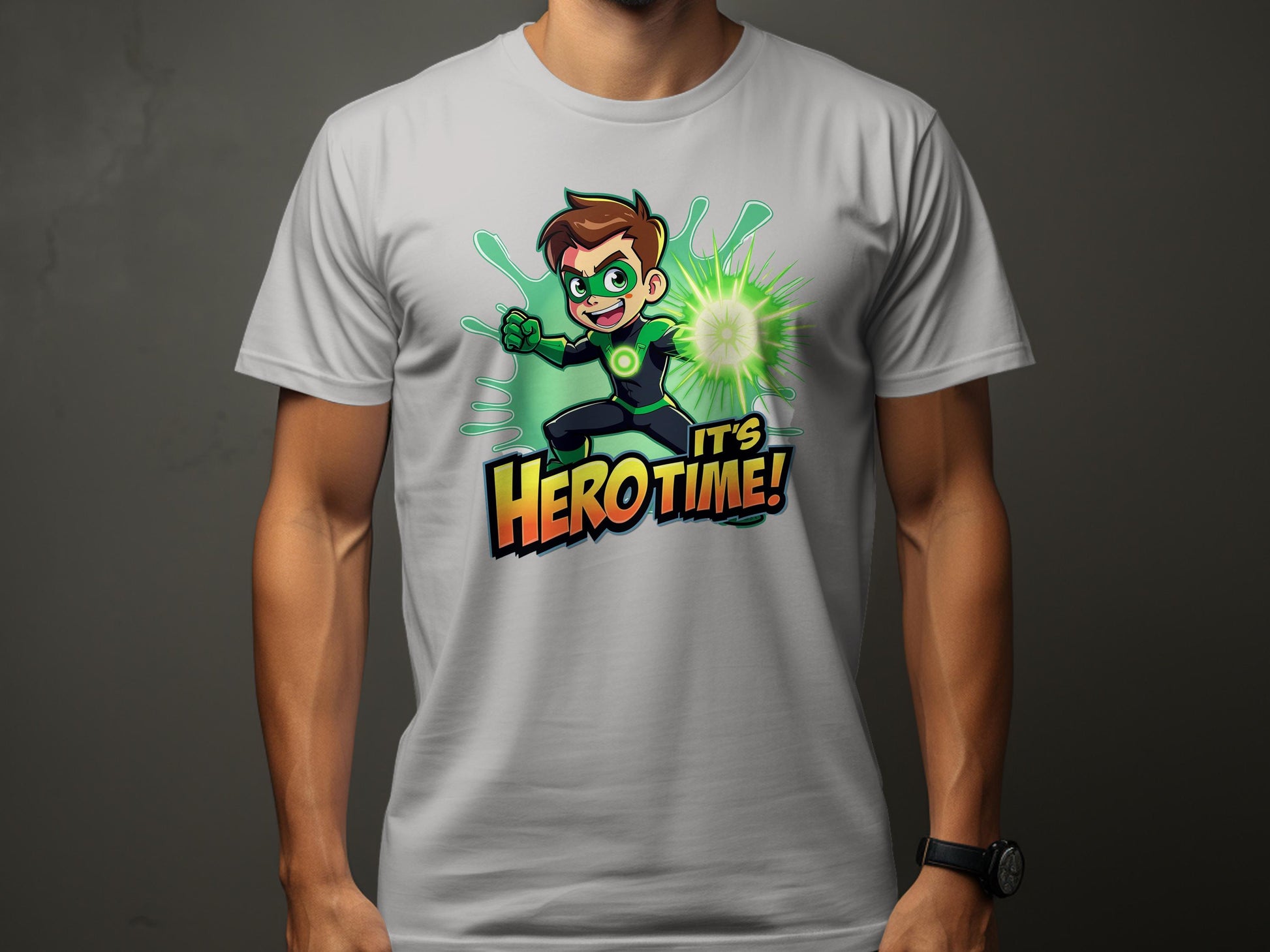 A vibrant white superhero T-shirt from Garment Graphics, featuring a cartoon character in a green suit and gloves emitting green energy. The brown-haired heros determined expression is captioned with Its Hero Time! Available in family sizing for matching heroic ensembles!.