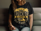 A person wears a black Garment Graphics T-shirt in womens sizing, featuring the humorous message, If hes got golf clubs in his truck or a camper in his driveway, I dont hire him! The quirky design includes yellow and white lettering with a small camper graphic.