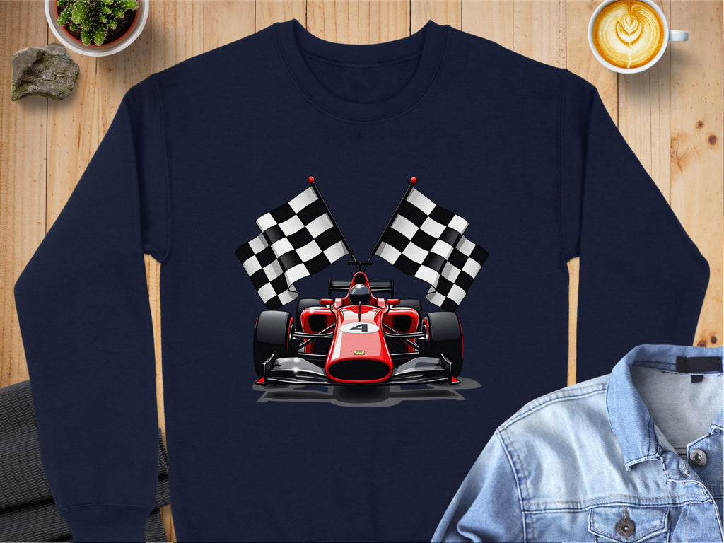 The navy sweatshirt by Garment Graphics features a bold graphic of a red Formula 1 car with crossed checkered flags. Its styled on wood next to a denim jacket, cappuccino, plant, and notebook. Perfect for motorsport fans!.