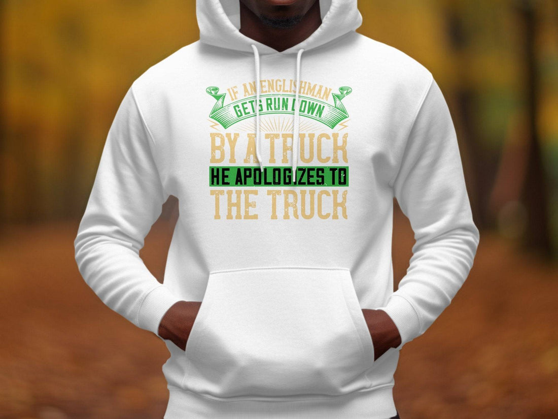 The Garment Graphics hoodie showcases the humorous text If an Englishman gets run down by a truck, he apologizes to the truck in green and yellow. Surrounded by festive pinecones and ornaments, its ideal for those who enjoy English etiquette with a humorous twist.