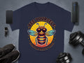 Navy T-shirt by Garment Graphics displays a stylish bee in sunglasses with Bee Yourself, Everyone Else Is Taken text in a circular design. Its surrounded by a smartphone, smartwatch, sneakers, dumbbells, and speaker on gray. Part of the family-friendly Every One Else Is Taken collection.