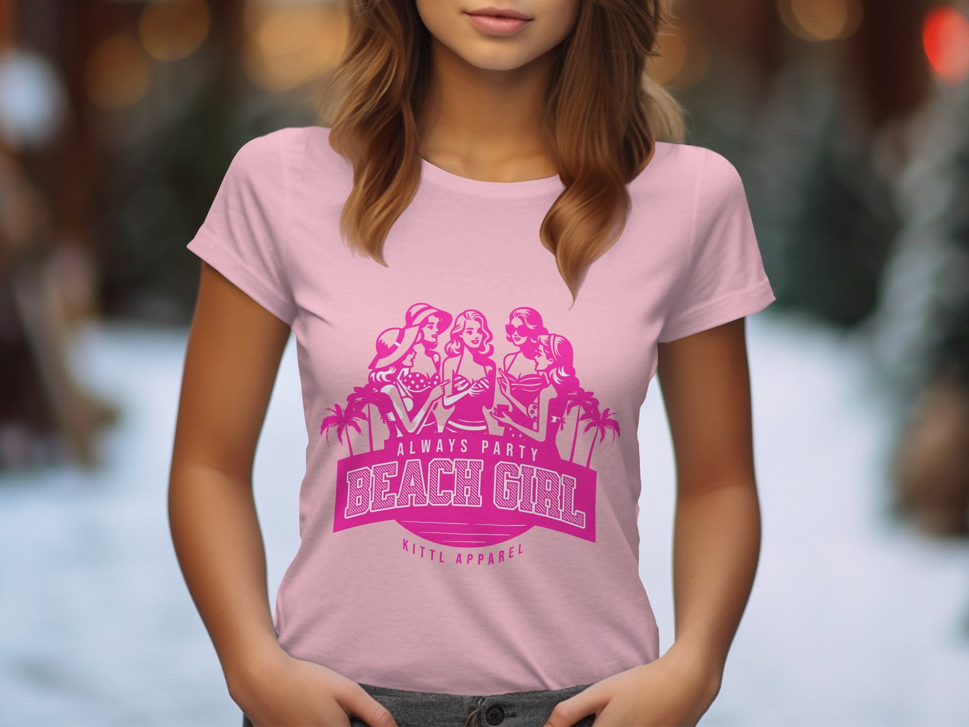 A woman sports a light pink t-shirt with three stylized figures, palm trees, and Always Party Beach Girl text, designed for Beach Girl T-Shirt enthusiasts by Garment Graphics. The blurred backdrop shows outdoor greenery.