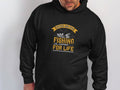 A fishing enthusiast wears a black Garment Graphics hoodie with Father and Son Fishing Partners for Life in striking yellow and white, featuring a fish and crossed rods—ideal for celebrating the father-son fishing bond.