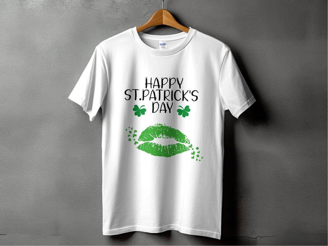The Garment Graphics T-shirt showcases a festive Happy St. Patricks Day message with green lips and clovers. Hanging against a plain gray wall, it perfectly blends style and celebration.