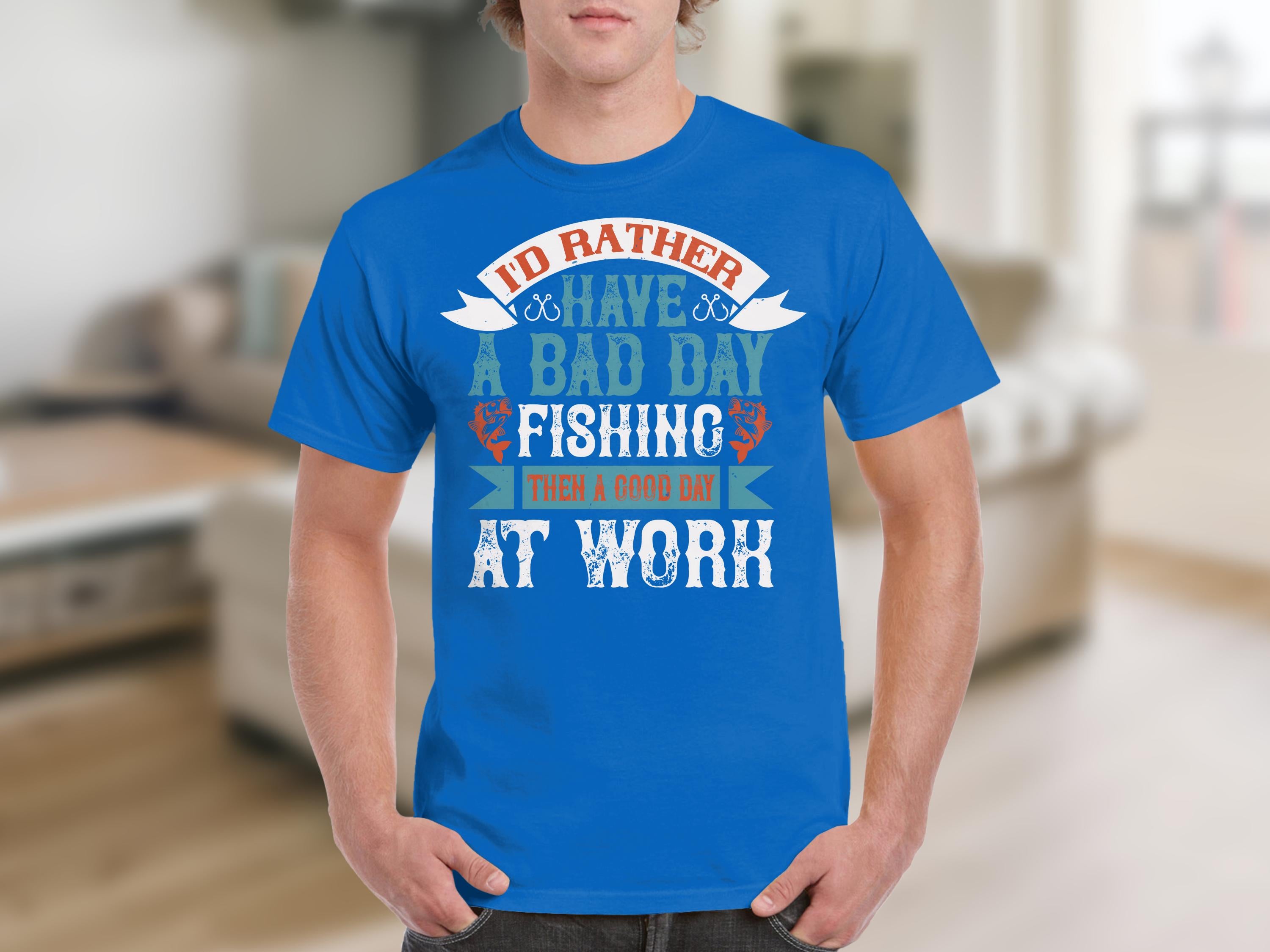 A person in a Garment Graphics blue fishing t-shirt with Id rather have a bad day fishing than a good day at work stands out against the blurred indoor setting, making it a clever gift idea for anglers.