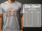 A person wearing a Garment Graphics light gray tee with This Day is Powered by Coffee exudes positivity. Nearby, a size chart for classic fit Gildan 5000 heavy cotton tees shows measurements from S to 5XL.