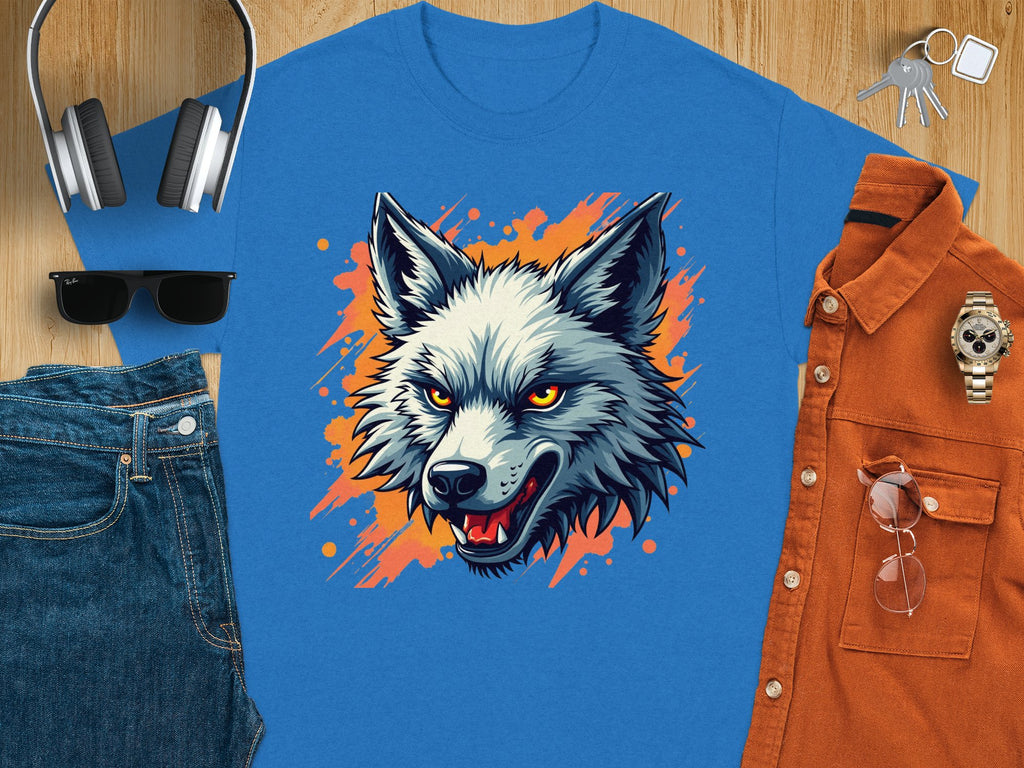 The Garment Graphics stylish T-shirt features a wolf graphic with orange and white accents. Paired with headphones, keys, a watch, an orange button-up shirt, sunglasses, and blue jeans on a wooden surface—it creates the perfect ensemble for a fearless personality.