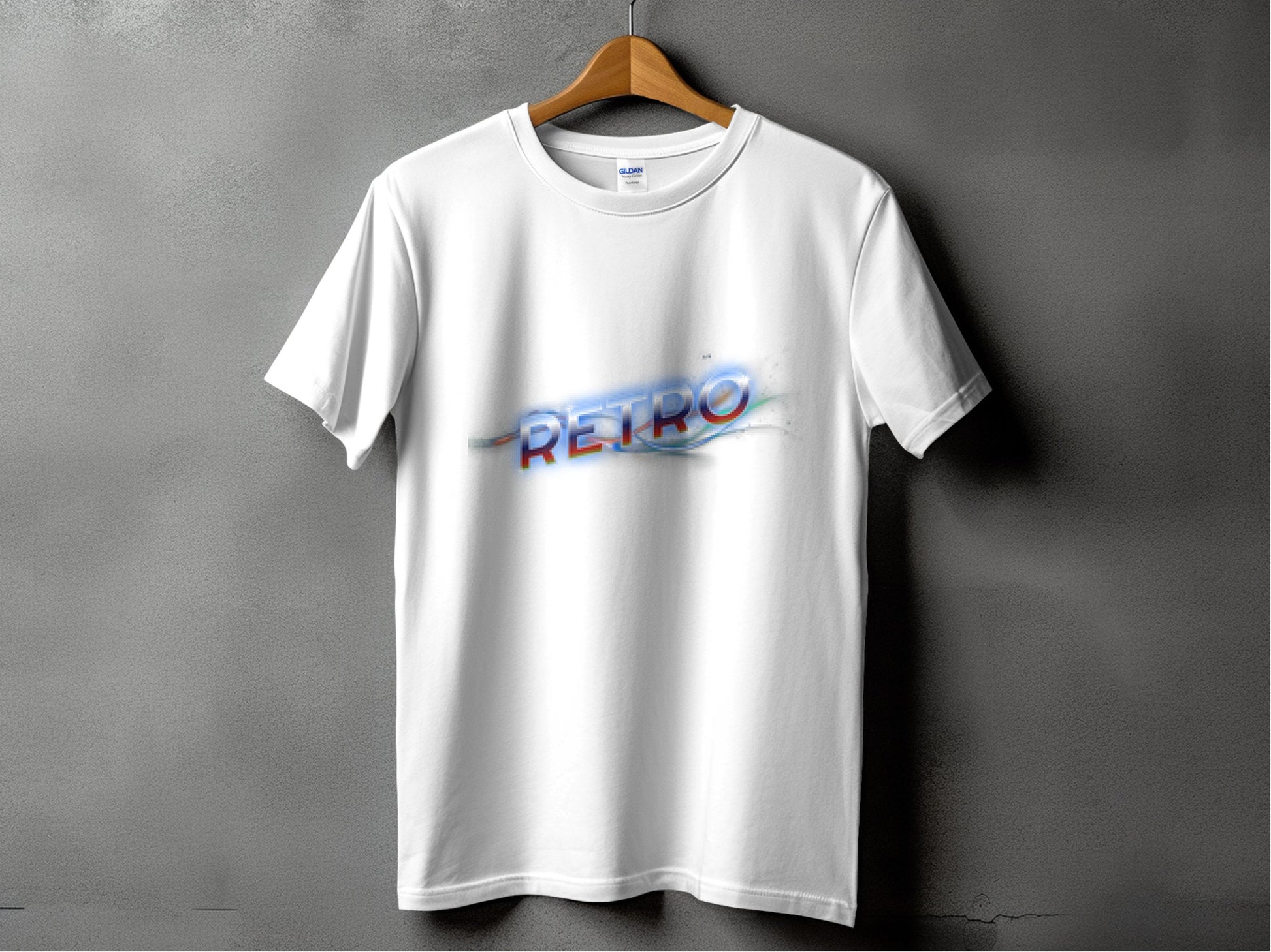 A white T-shirt by Garment Graphics hangs on a wooden hanger against a gray backdrop. It exudes vintage charm with RETRO in large, multi-colored letters across the chest, showcasing classic fit and retro graphic design.